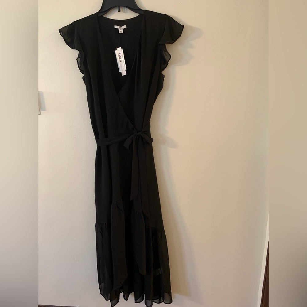 Bar III black wrap dress. Sheer ruffle bottom and cap sleeves.